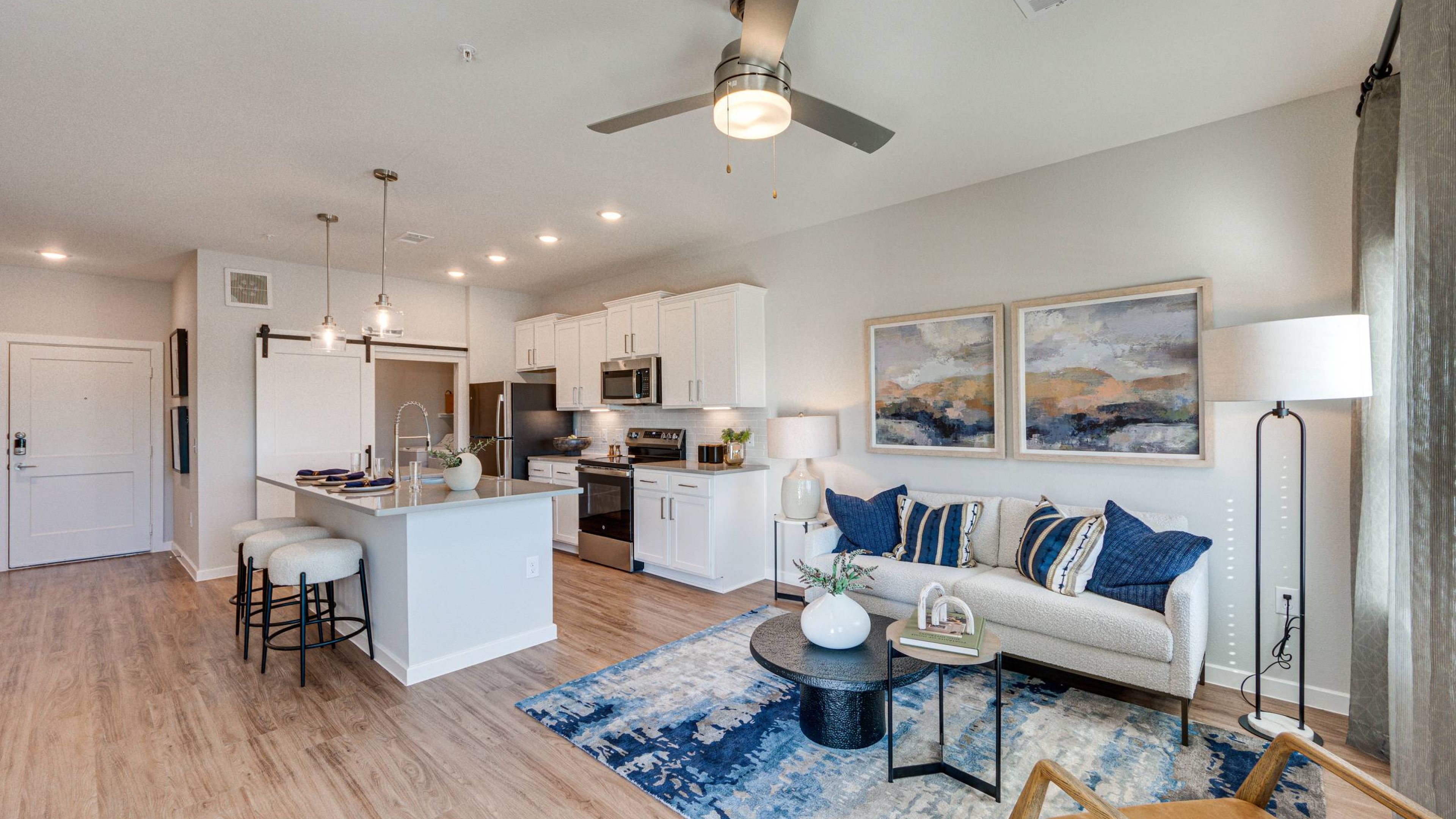 Hawthorne at Fairmont apartment kitchen area with wrap around kitchen island, stainless steel appliances, and ample cabinet storage